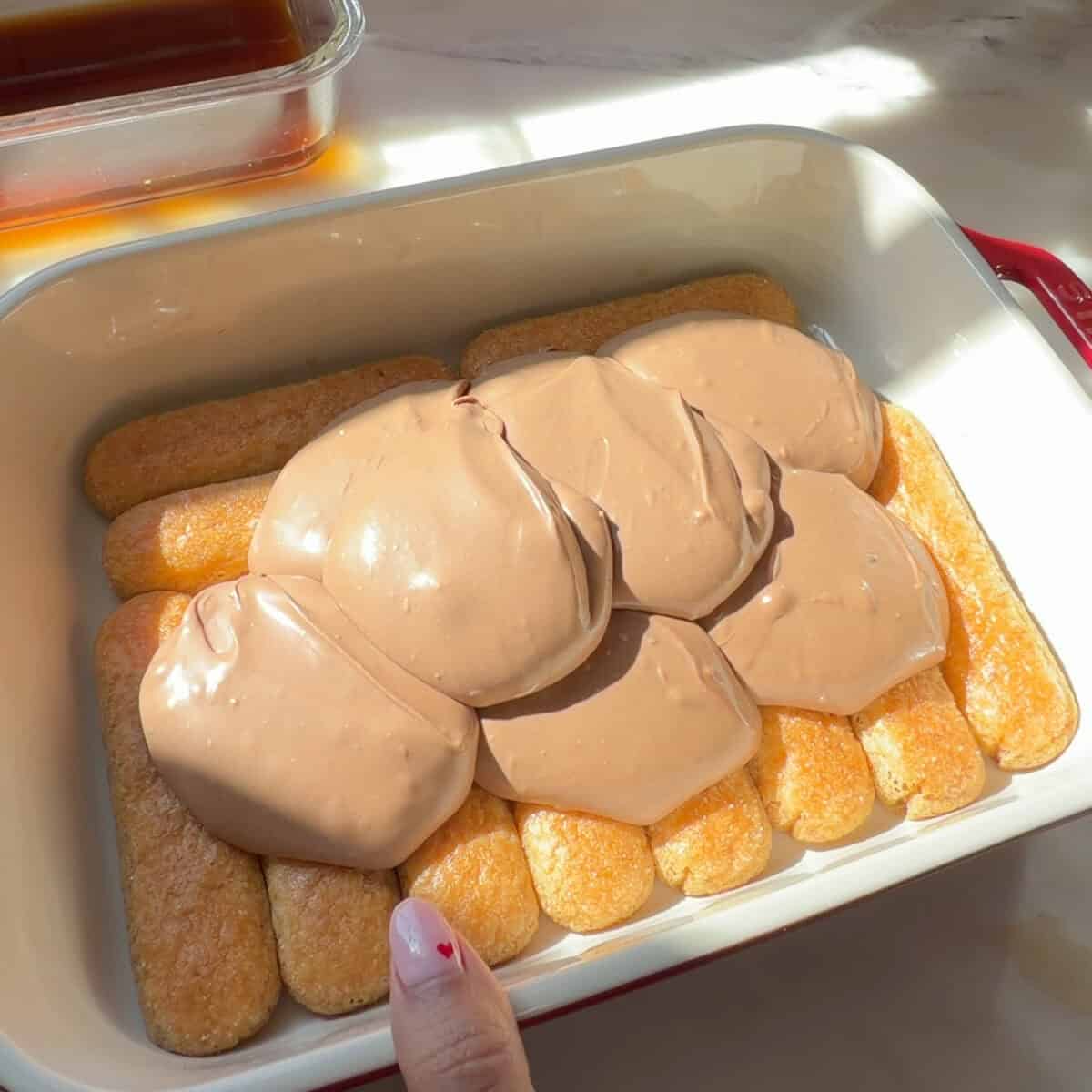 Layer of ladyfingers with chocolate mascarpone scooped on top.