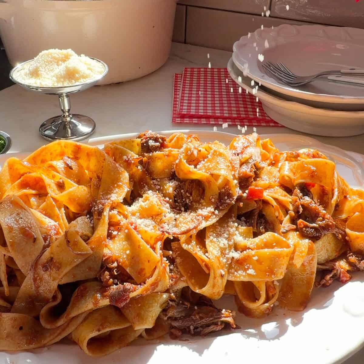 शॉर्ट रिब रागु पास्ता पर परमेसन छिड़का हुआ।