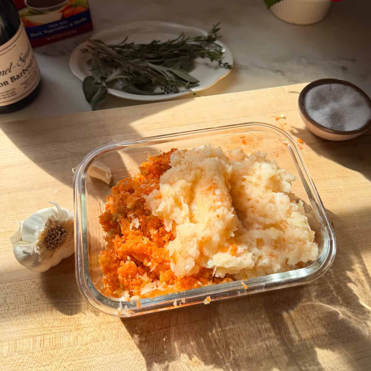 कटोरे में गाजर, अजवाइन, प्याज और लहसुन कीमा बनाया हुआ।