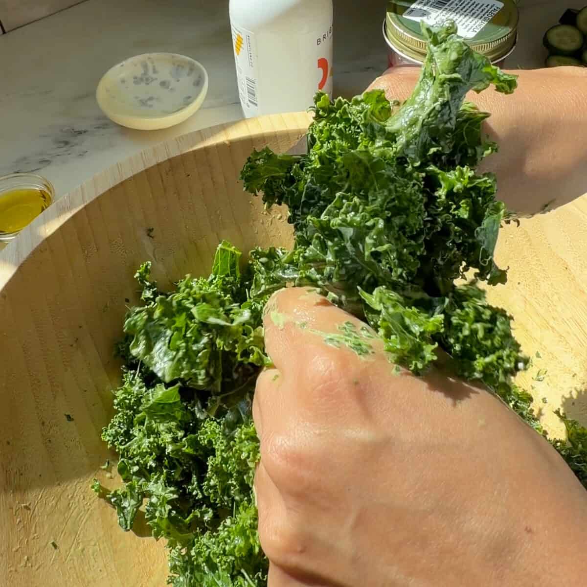 Massaging kale with creamy chimichurri dressing.