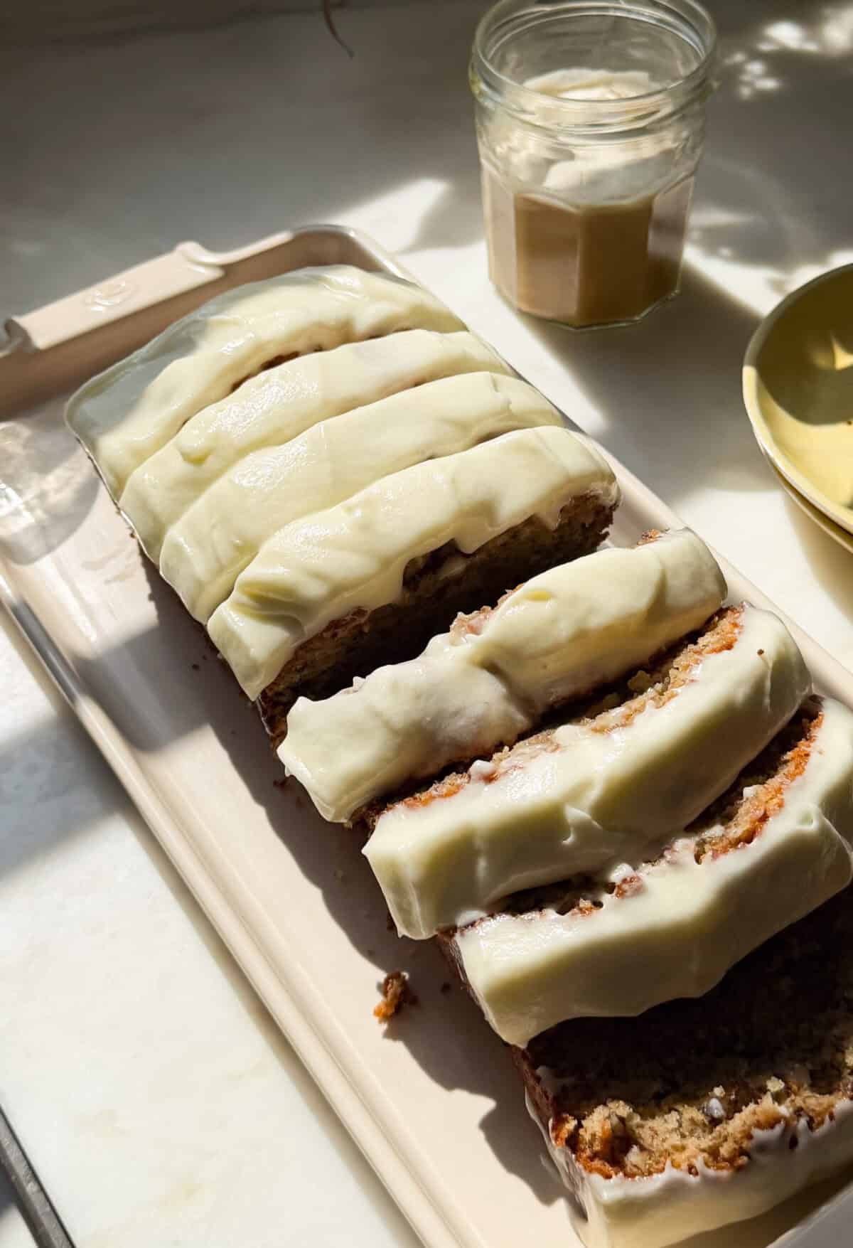 Sliced Butter Pecan Banana loaf on plate.