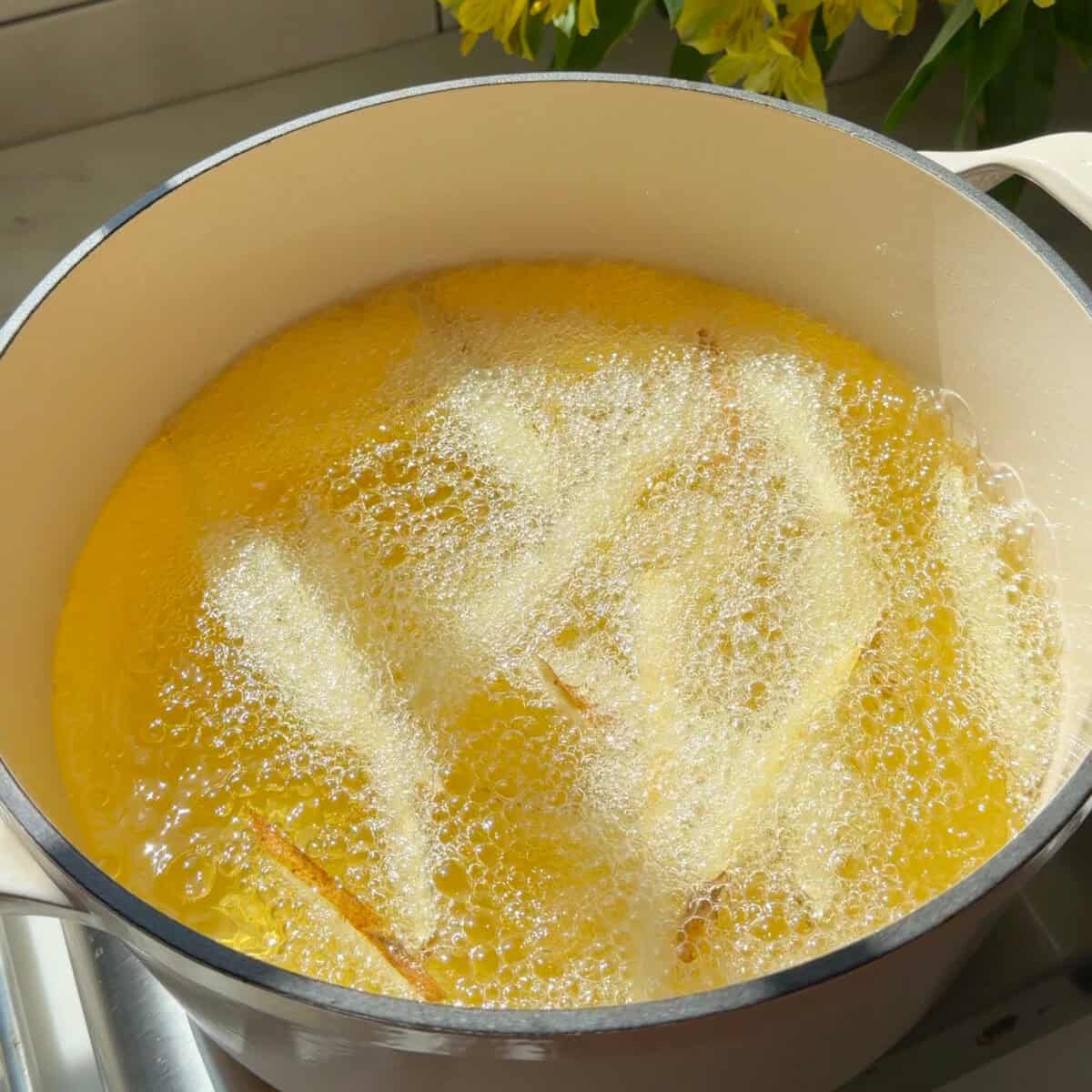 French fries frying in hot oil.