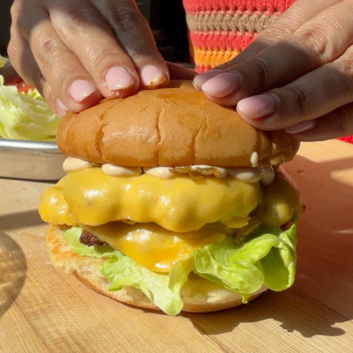 Hands pressing In-N-Out Burger.