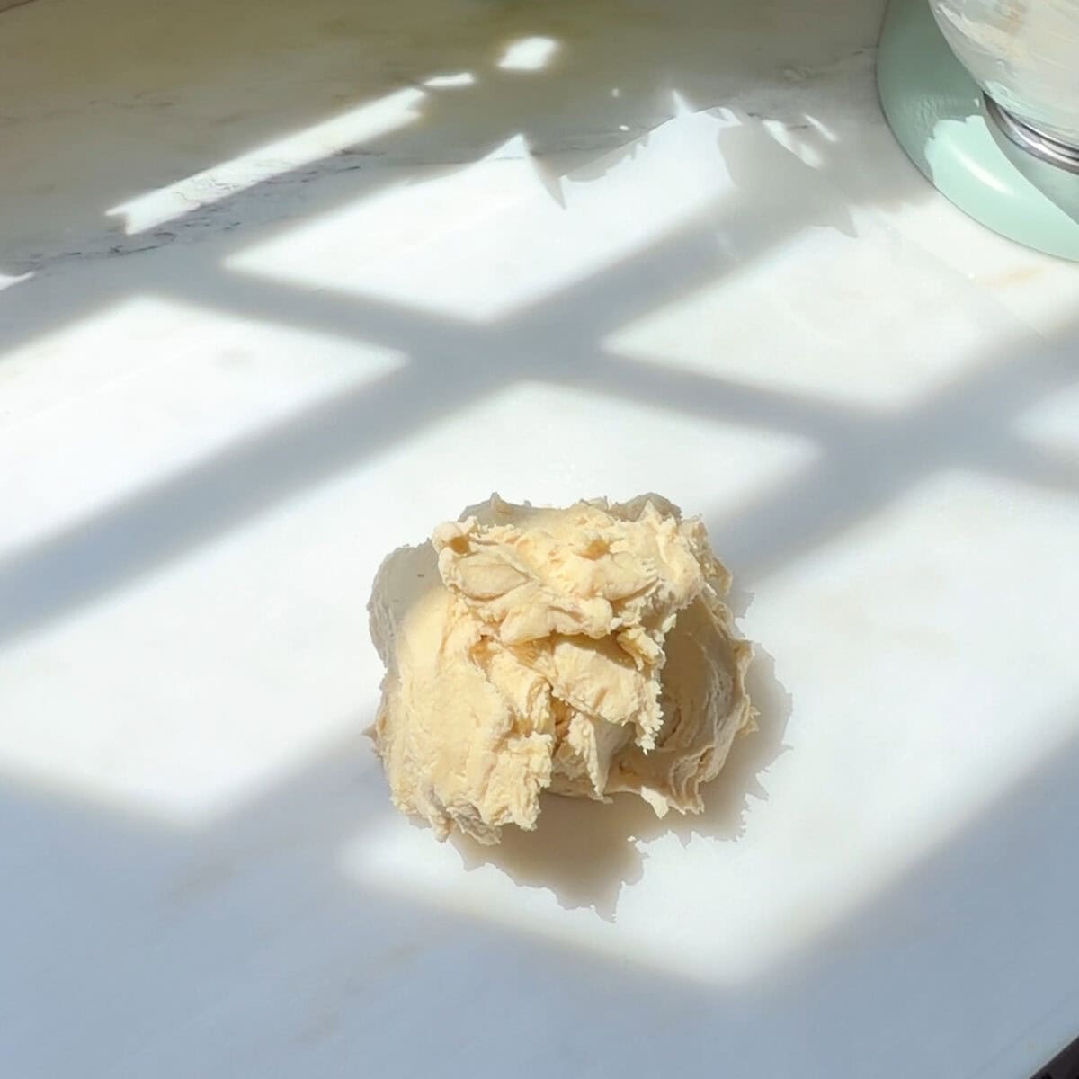 Ball of cookie dough on parchment.