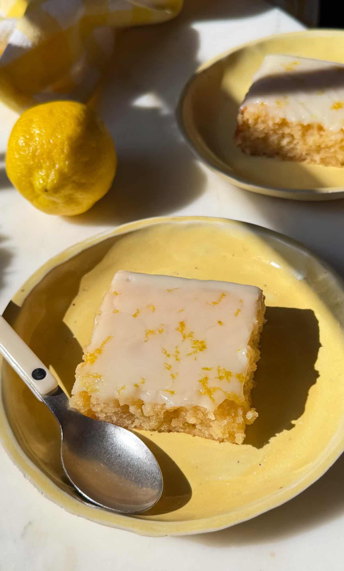 Lemon brownie on plate with spoon.