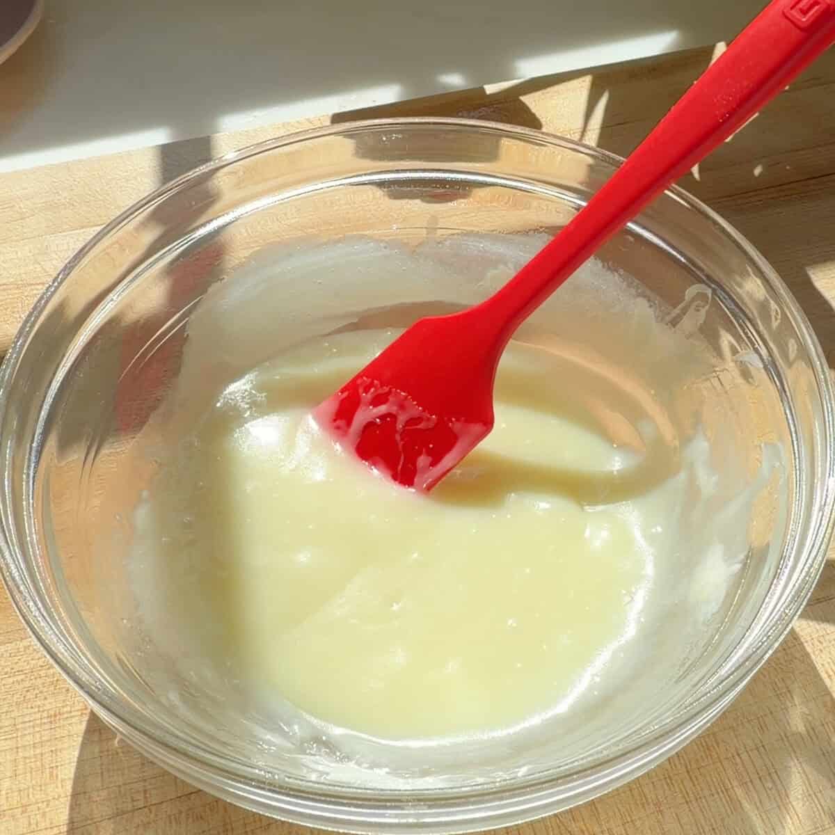 White chocolate lemon glaze in bowl.