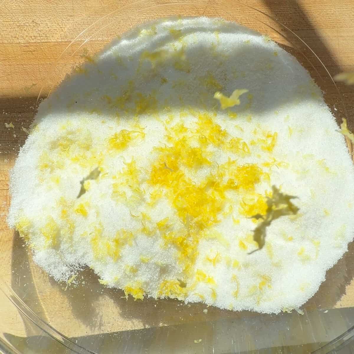 Sugar and lemon zest in bowl.