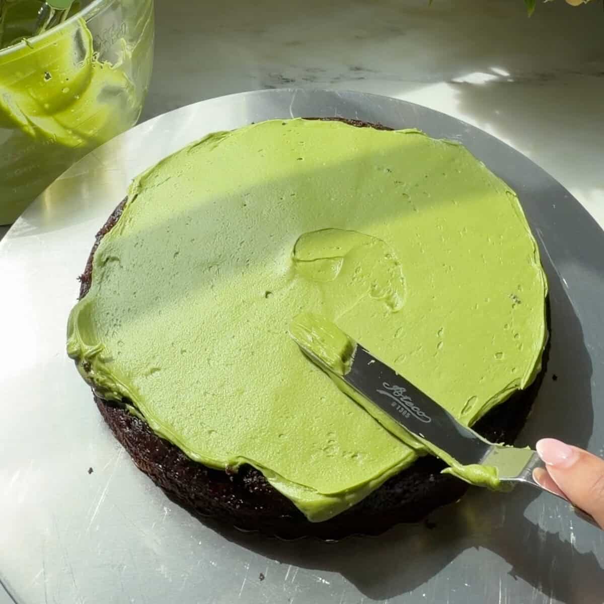 First chocolate cake layer with matcha frosting.