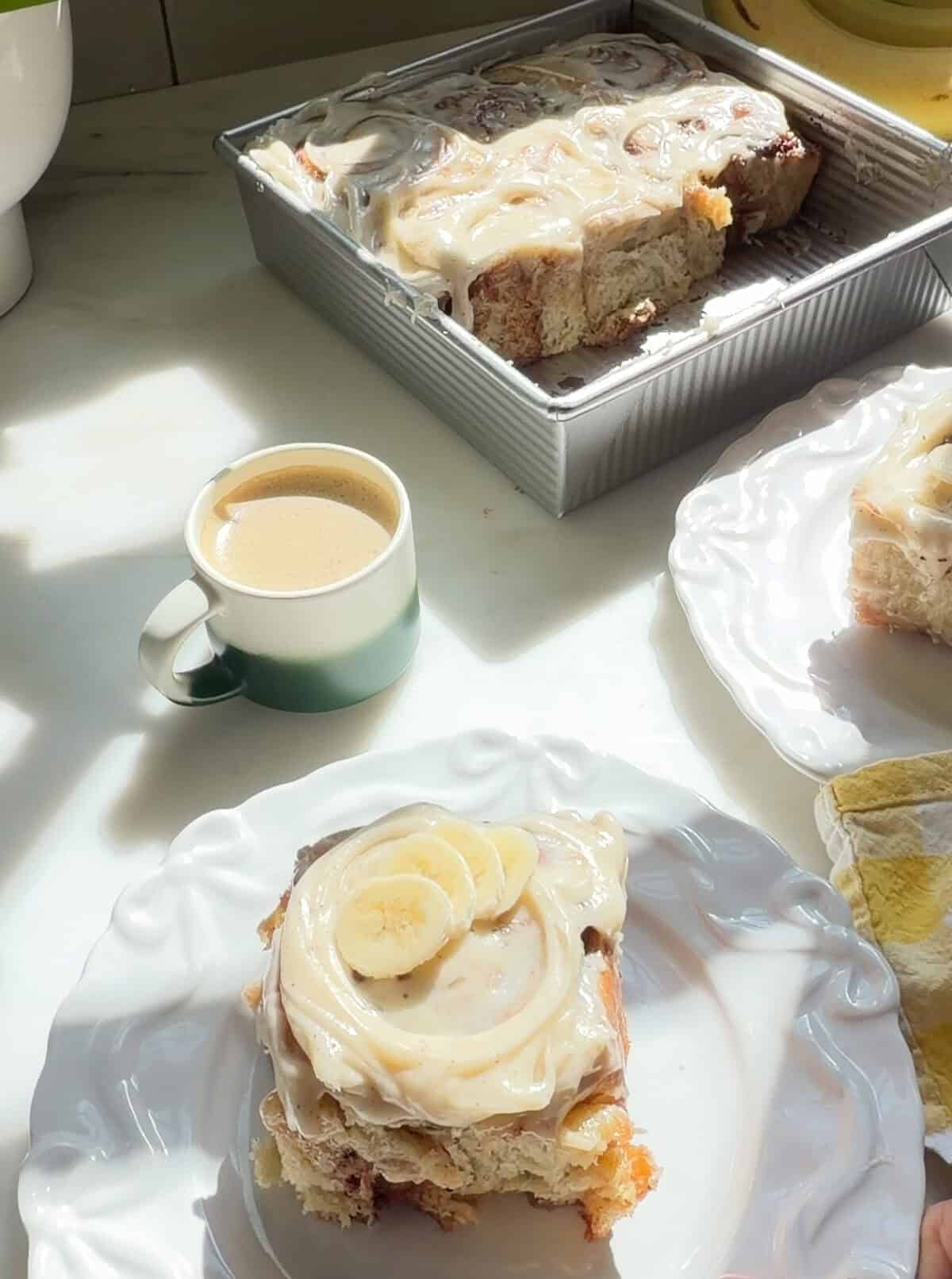Banana Bread Cinnamon Rolls in a baking dish and on plates.