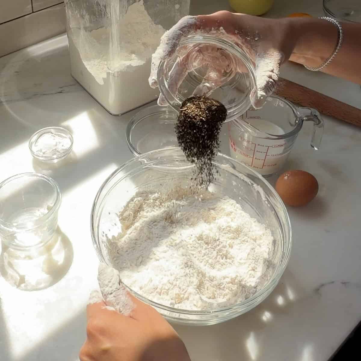 Adding earl grey tea leaves to flour mixture.