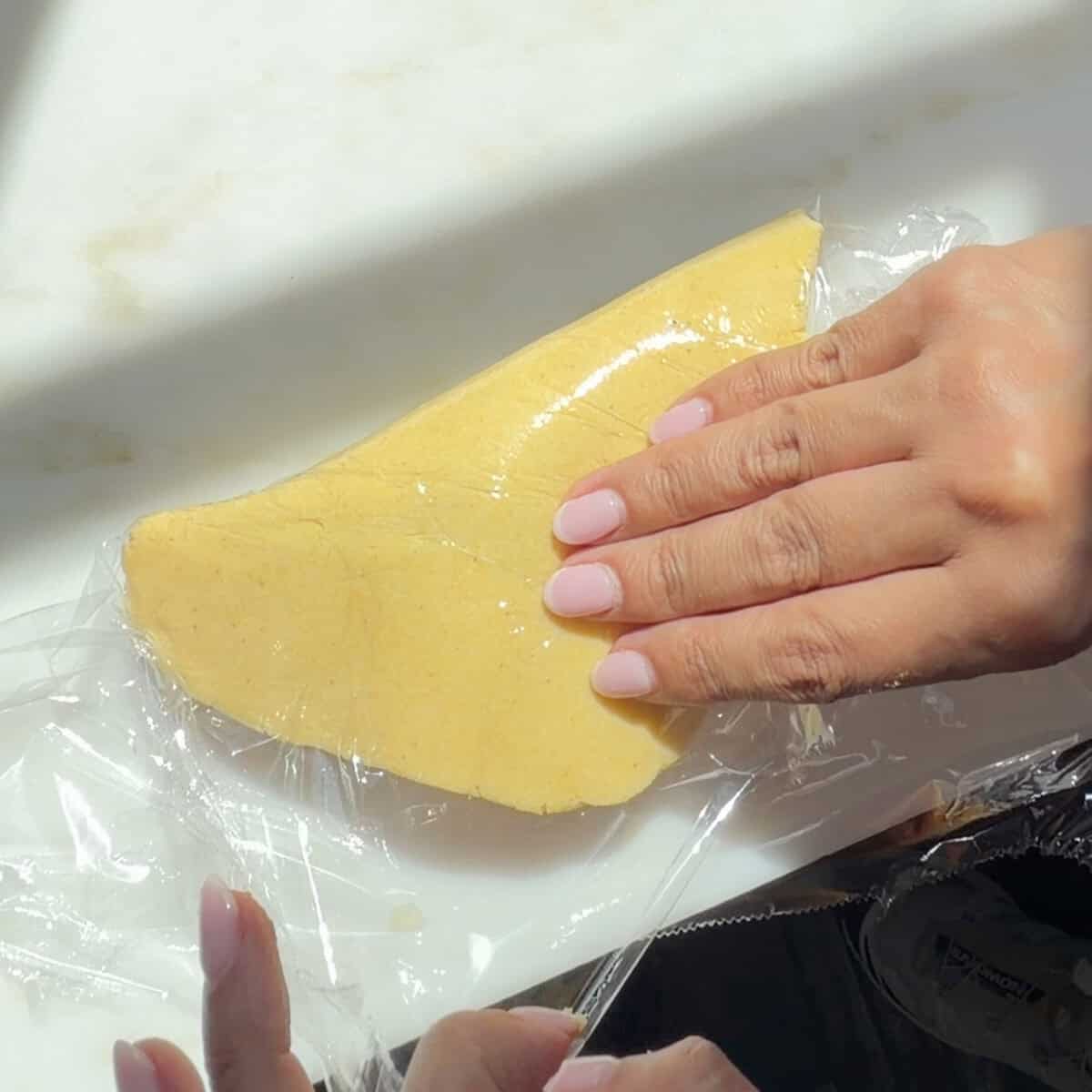 Folding empanada dough over the filling.