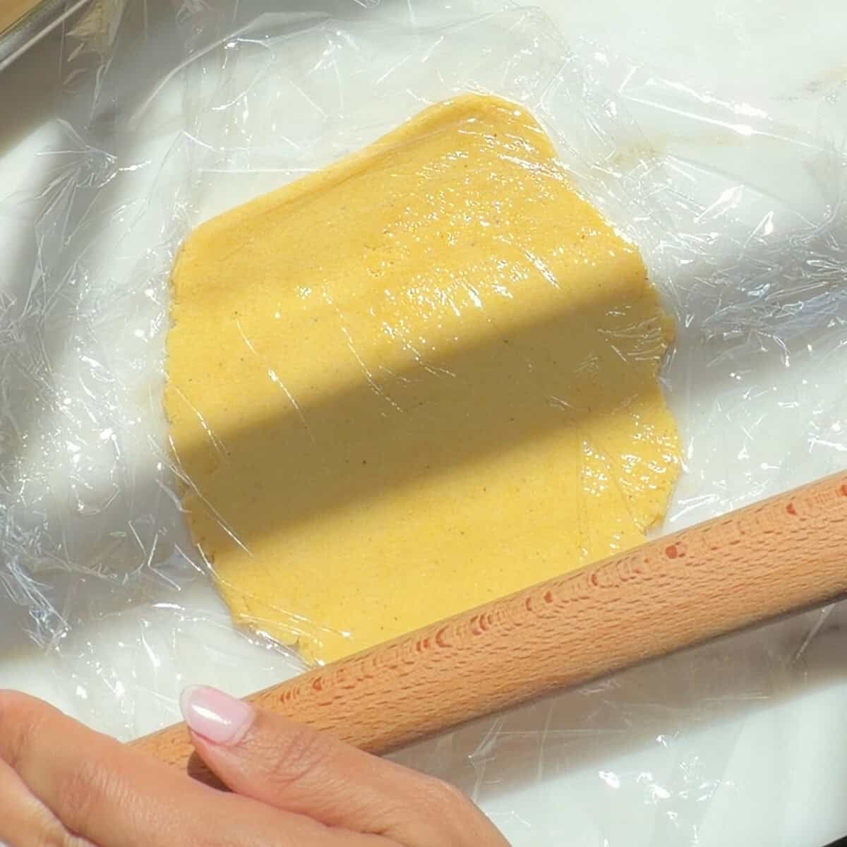 Rolling out empanada dough disc.