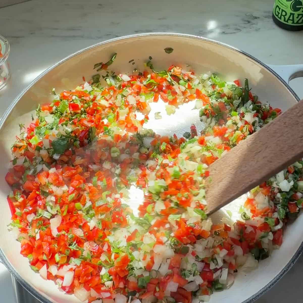 Sautรฉing sofrito mixture.