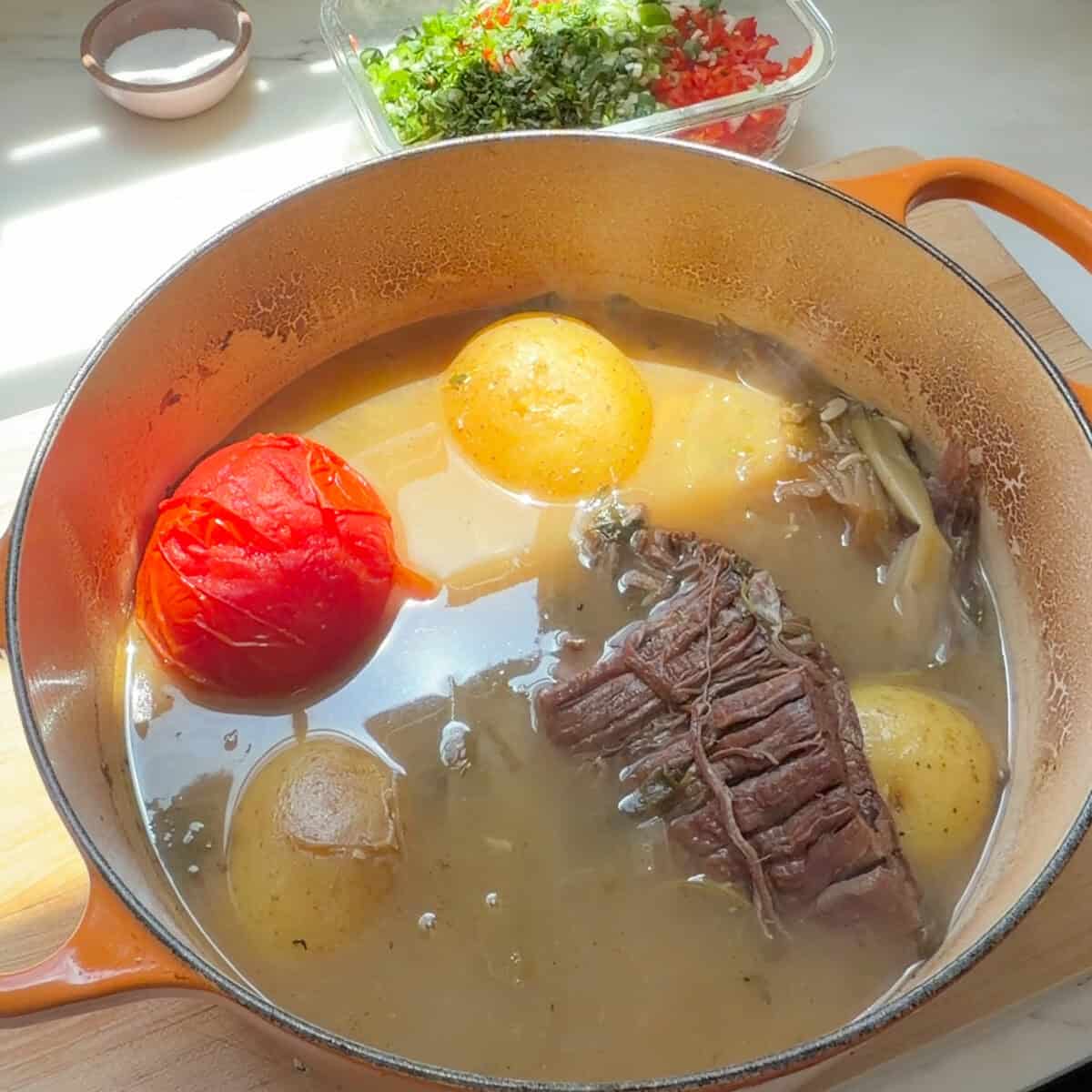 Braisde beef, tomato, and potatoes in broth.