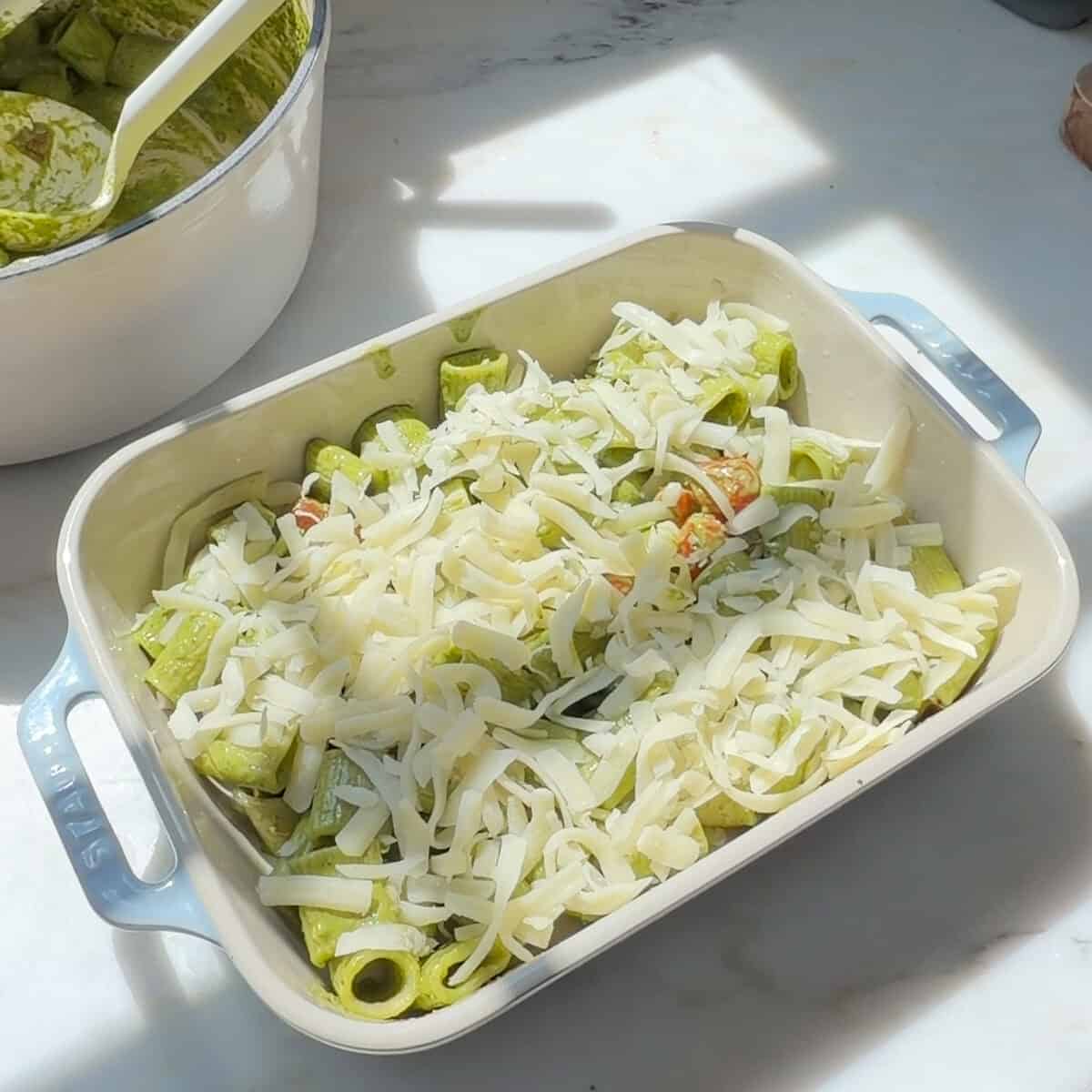 Layer of pesto pasta with shredded mozzarella.