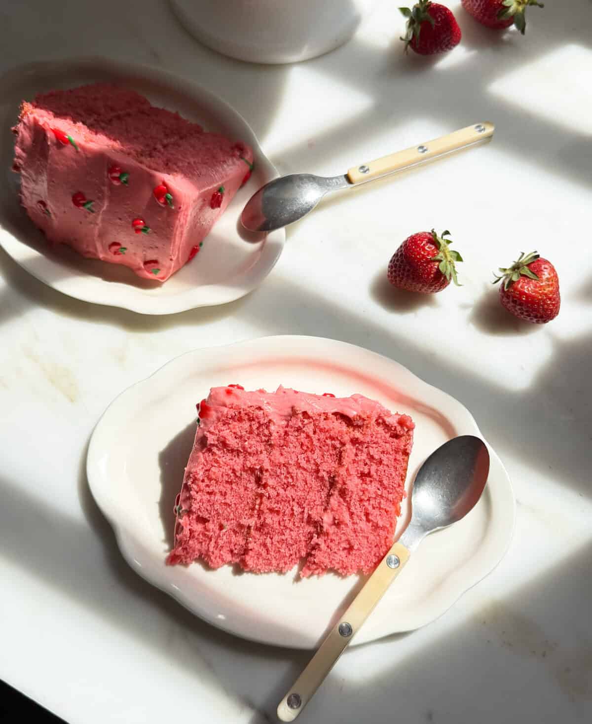 Strawberry Layer Cake slices on plates.