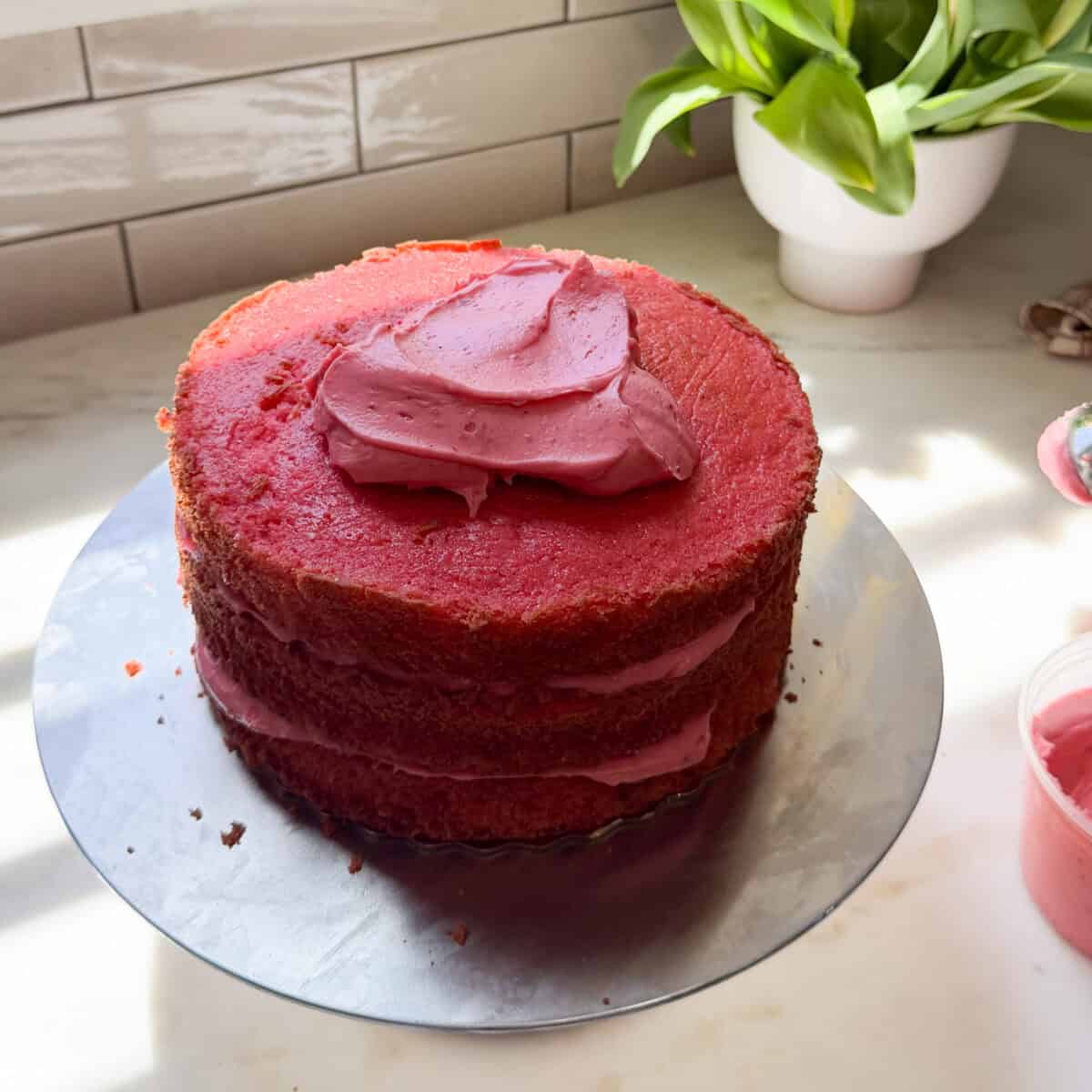 Strawberry Layer Cake partially frosted.