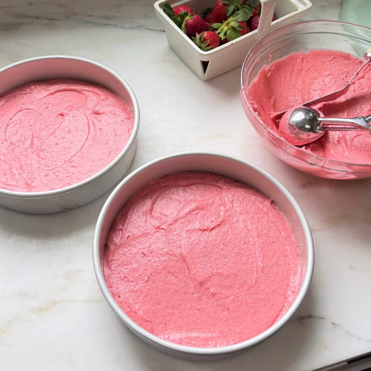 Strawberry Layer Cake unbaked layers in cake pans.