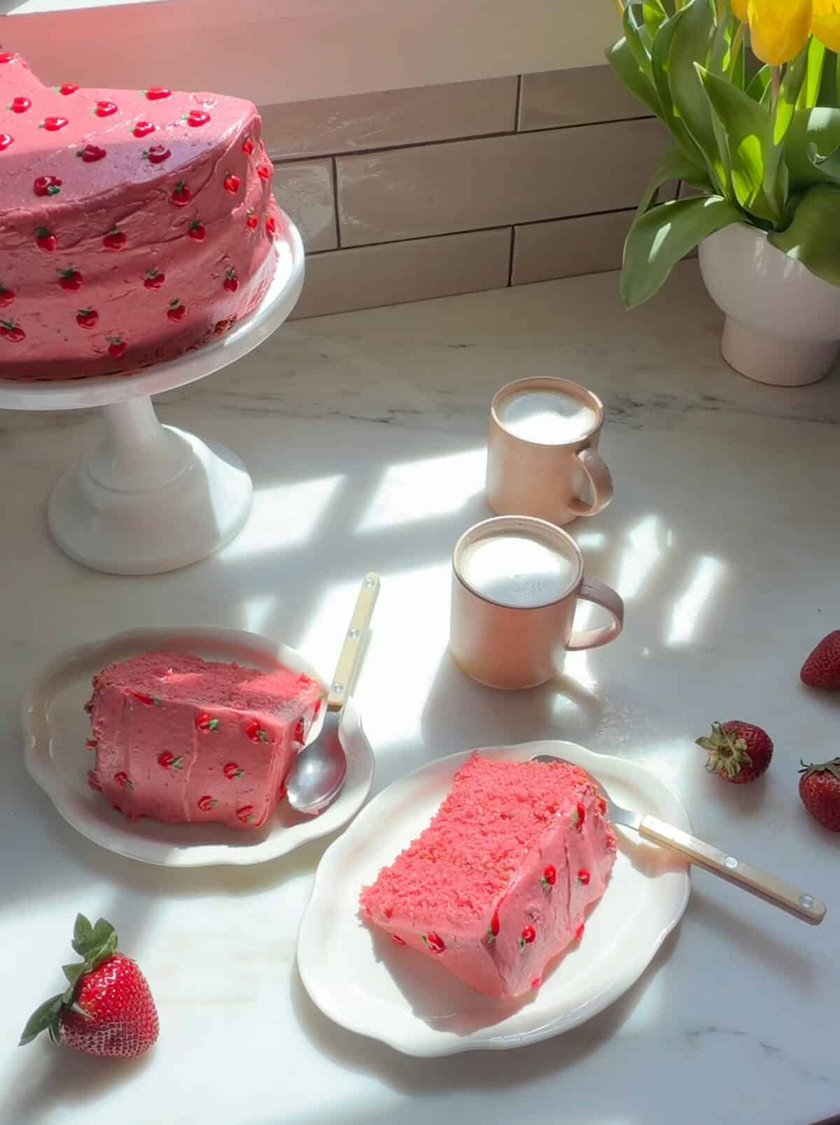 Strawberry Layer Cake slices, cake on cake stand, and cups of coffee.