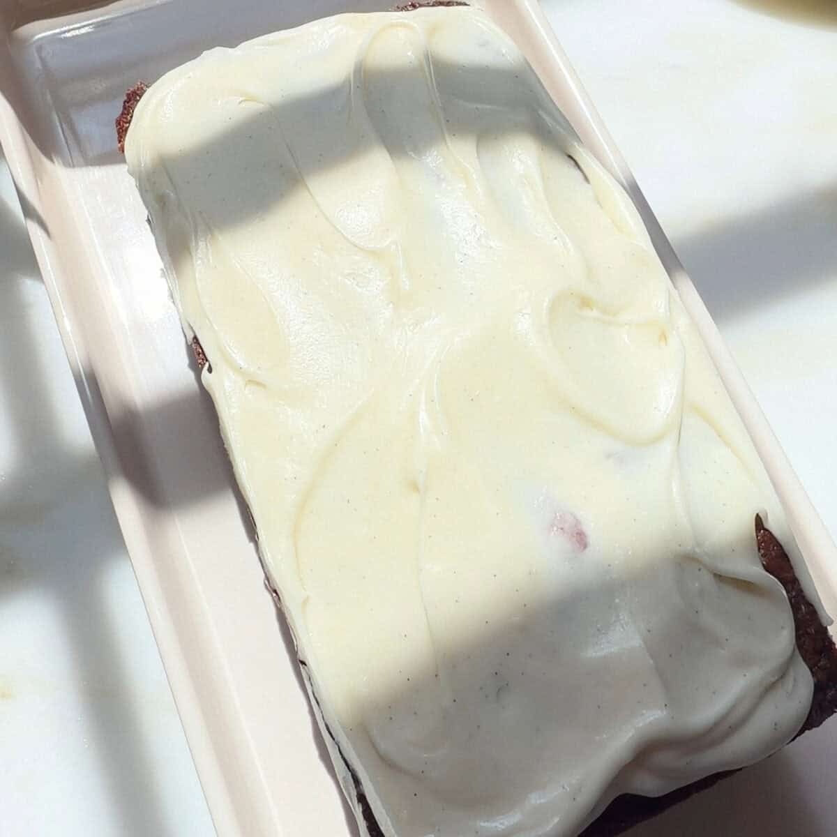 Tropical Banana Bread frosted on a plate.