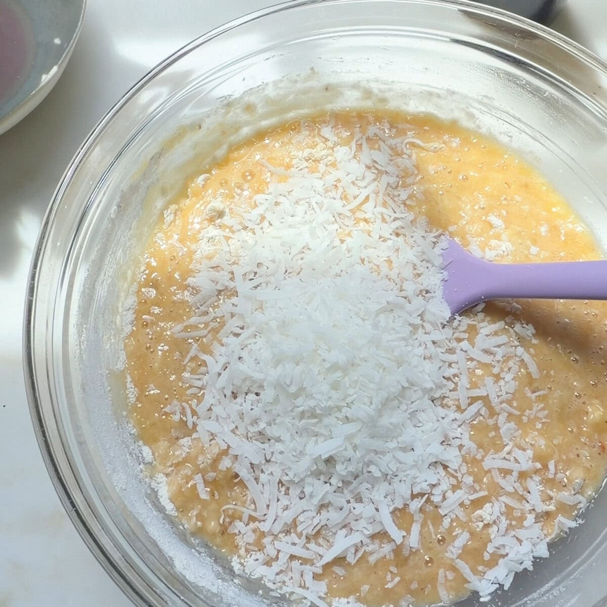 Tropical Banana Bread batter with coconut flakes.