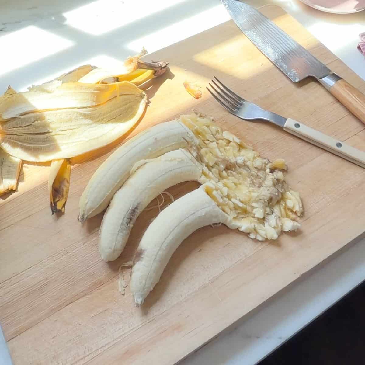 Smashed bananas on cutting board.