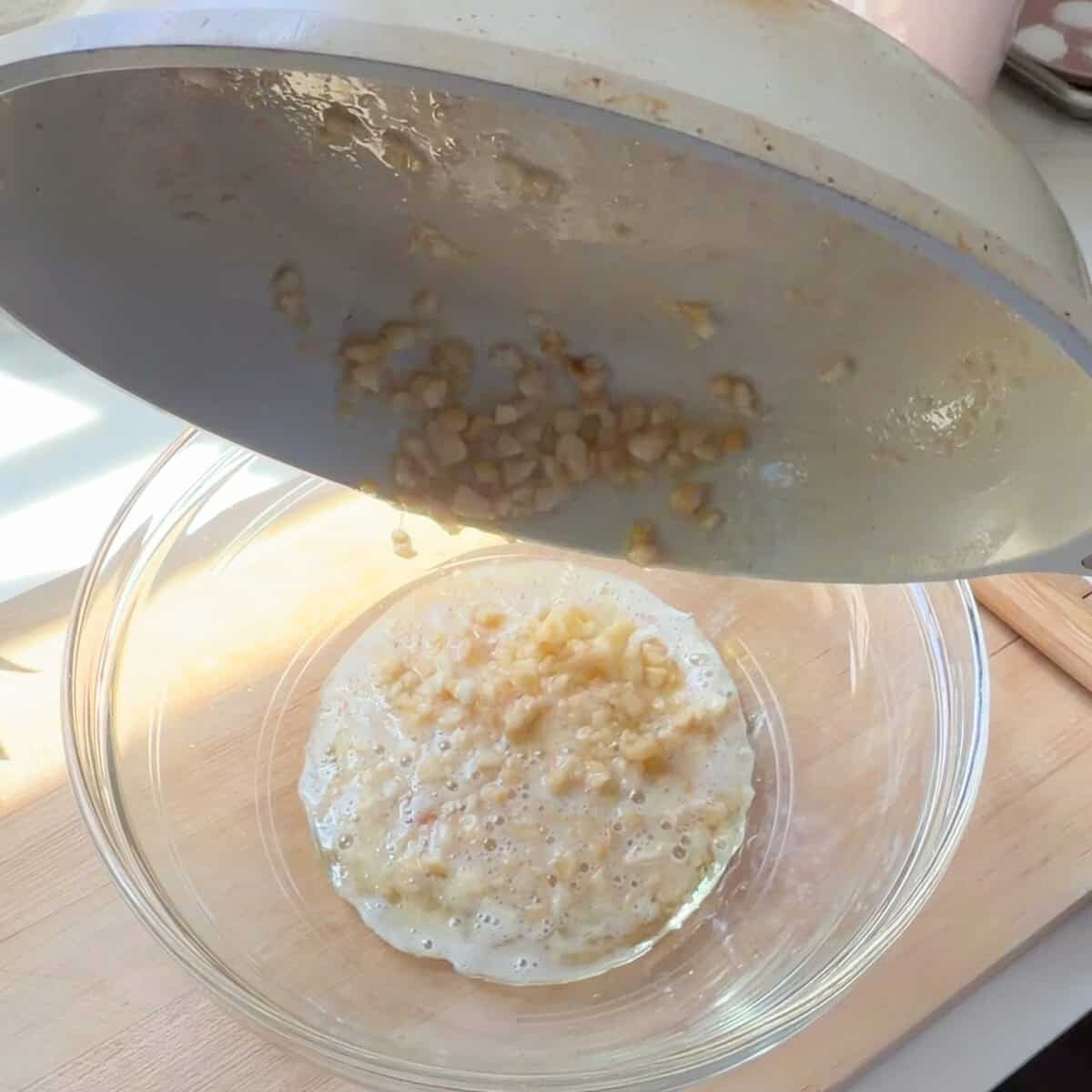 Melted butter-macadamia nut mixture going into bowl.