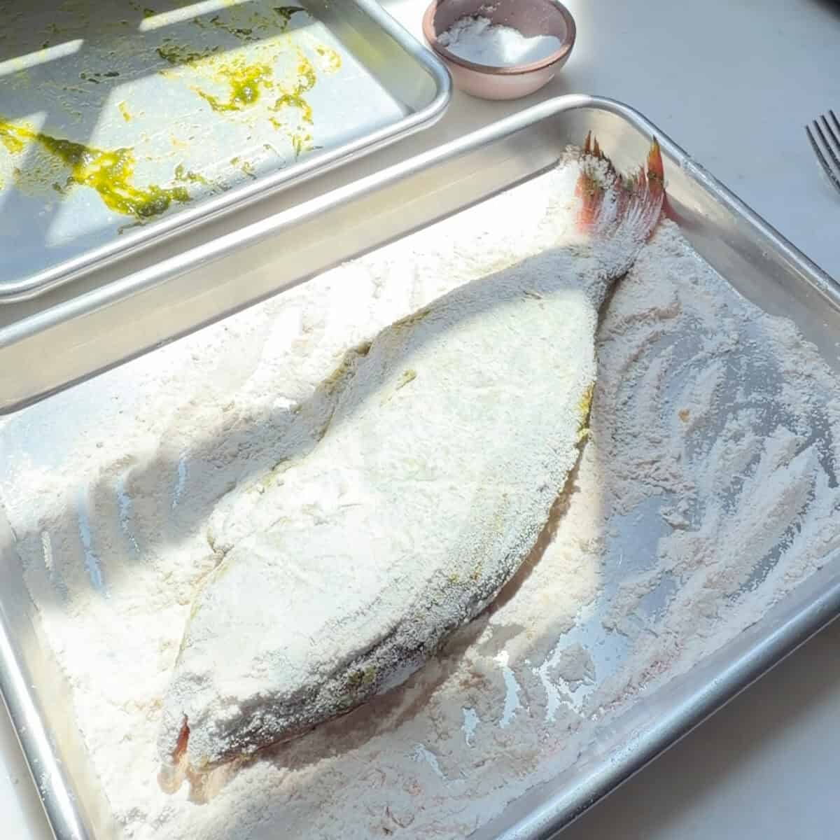 Marinated whole red snapper in flour dredge.