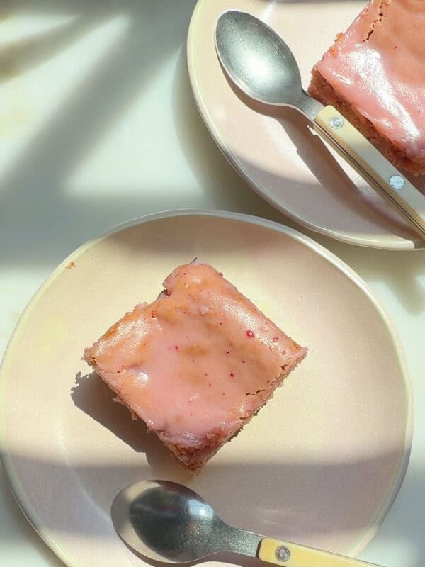 Slices of strawberry brownies on plates.