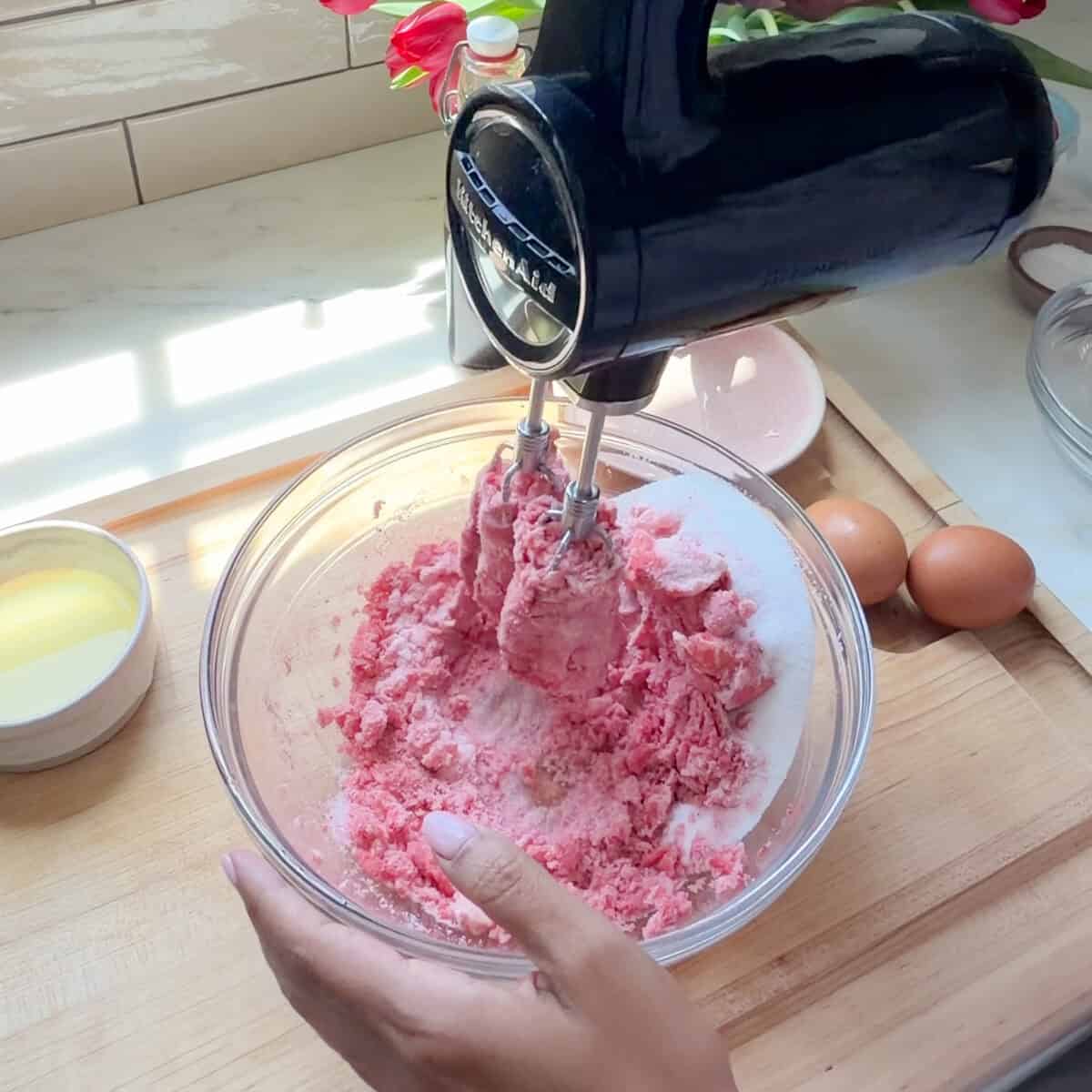 Beating the butter and sugar together with hand mixer.