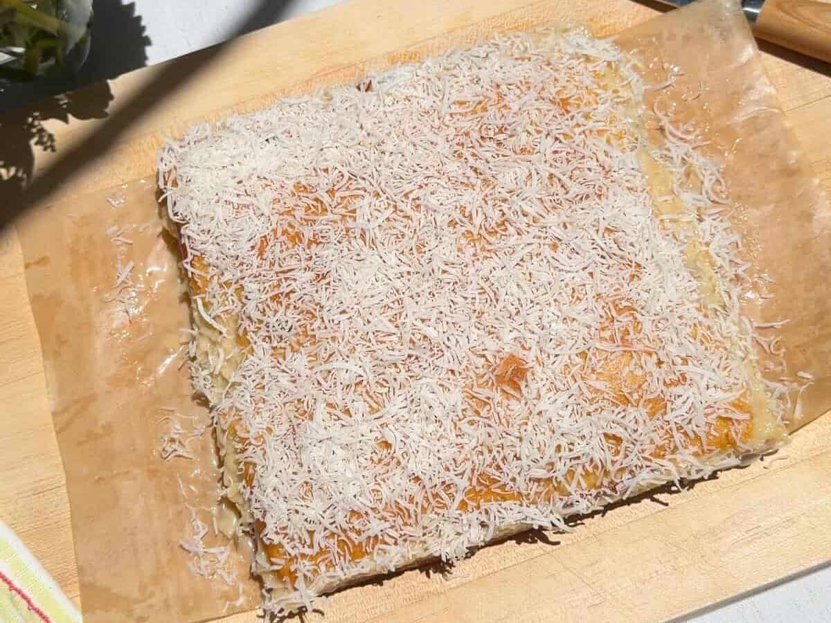 Whole cake on cutting board.
