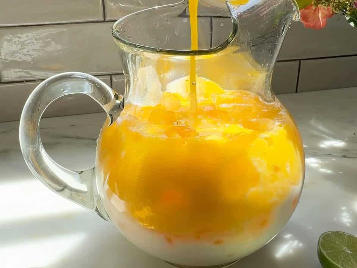 Pouring mango puree into pitcher.
