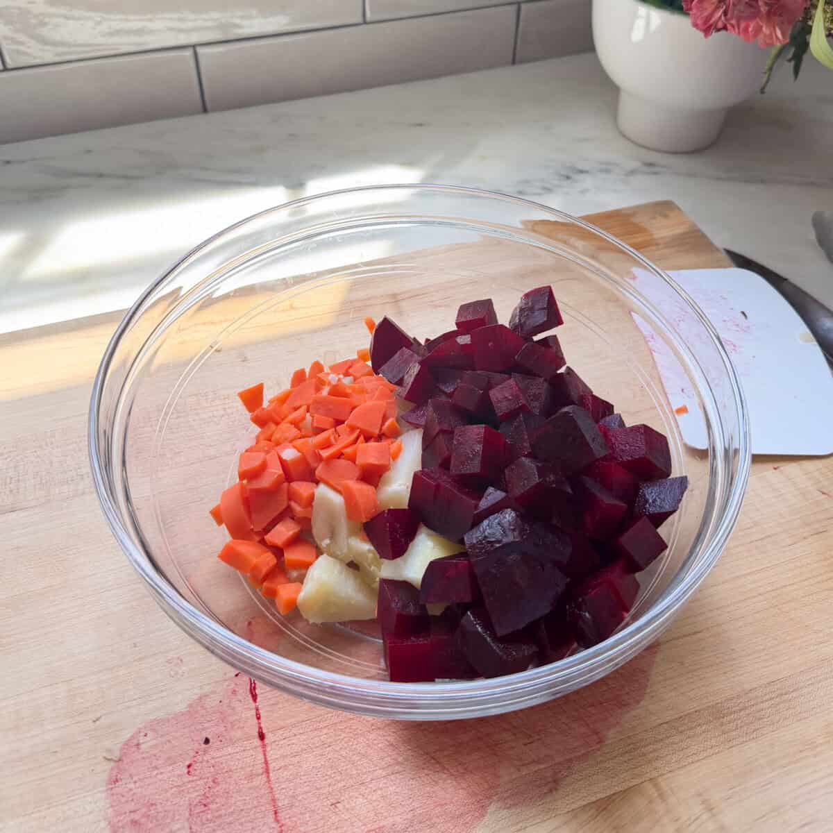 Diced beets, carrots, and potatoes in a bowl.