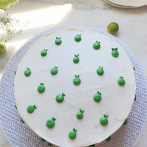 Whole key lime cake frosted and decorated with key limes.
