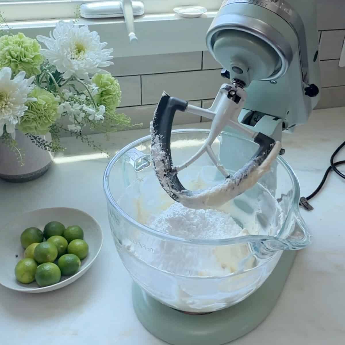 Powdered sugar added to the stand up mixer with creamed butter and cream cheese.