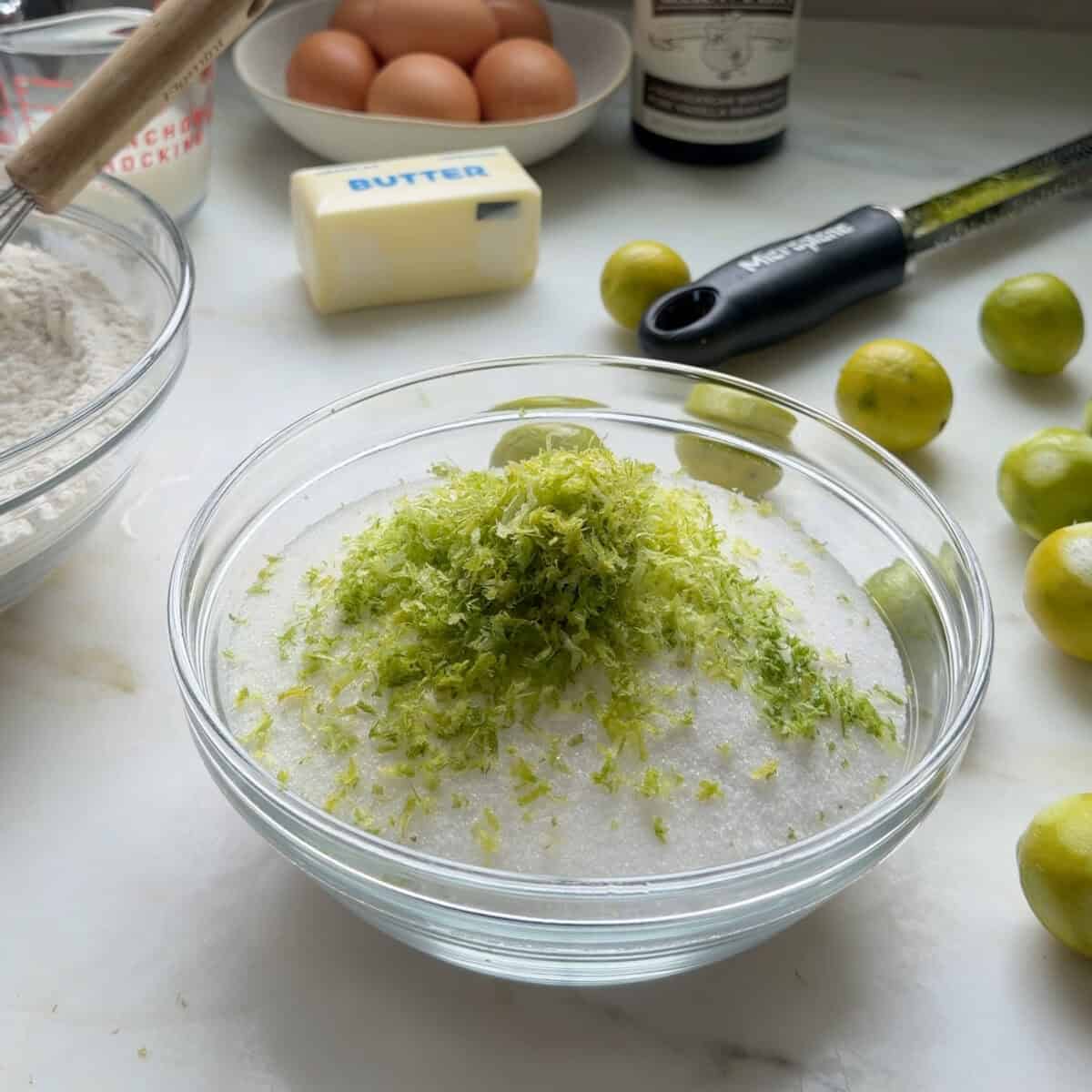 Key lime zest in a small bowl with sugar.