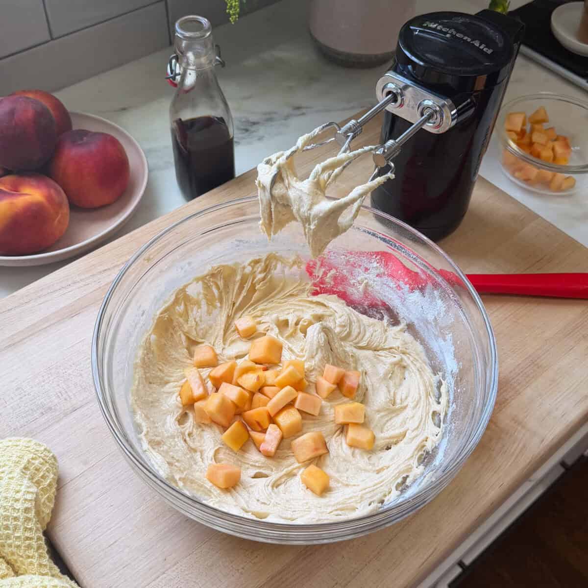 Adding peaches to Peach Cobbler Brownie batter.