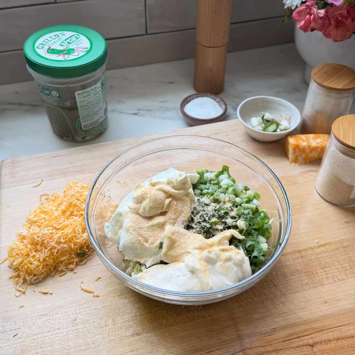 Chopped veggies, onions, mayo, and spices in a bowl.