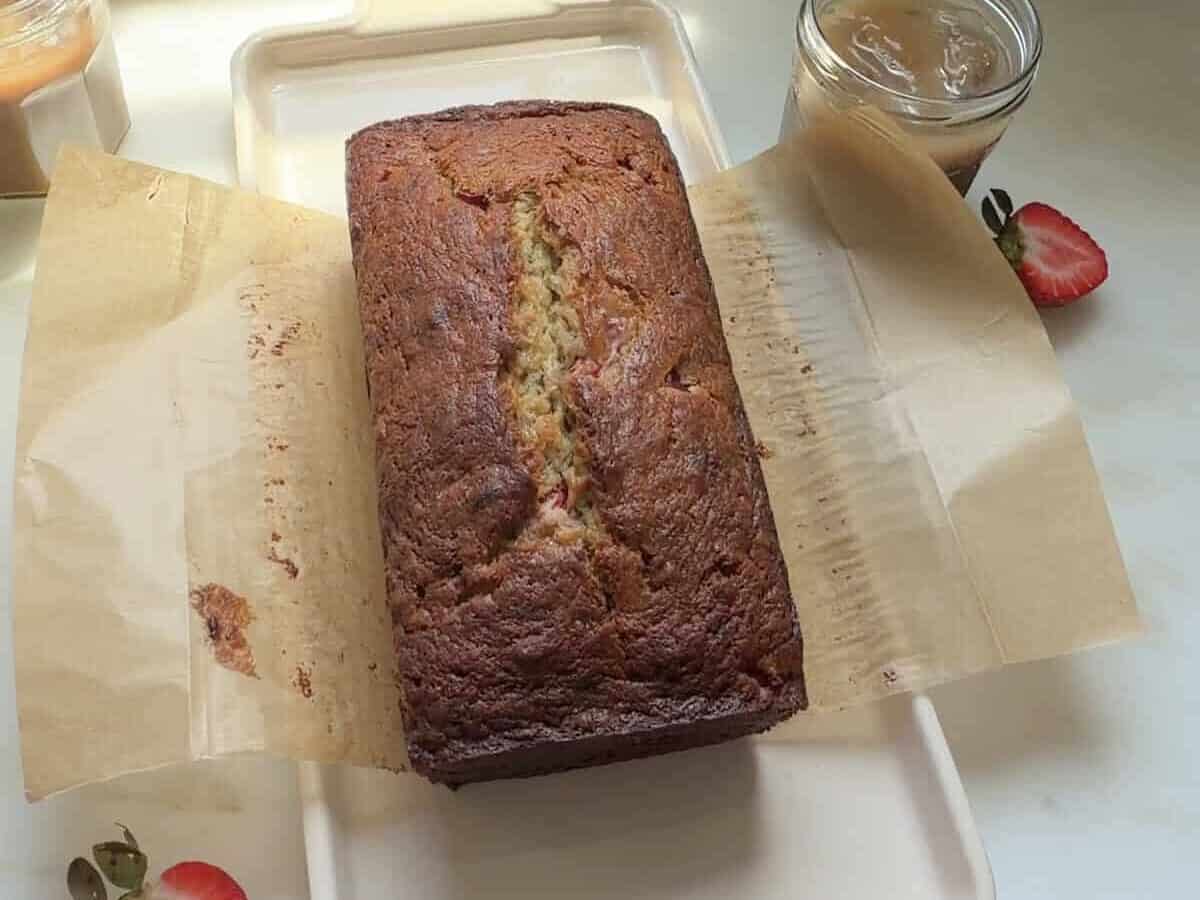 Strawberry banana bread loaf on a platter.