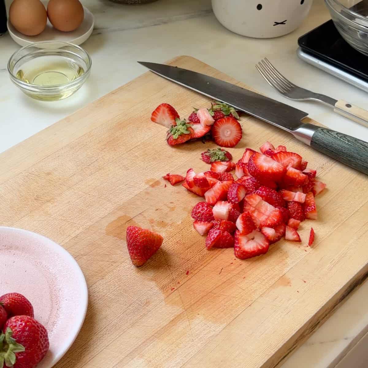 Diced strawberries on cutting board.