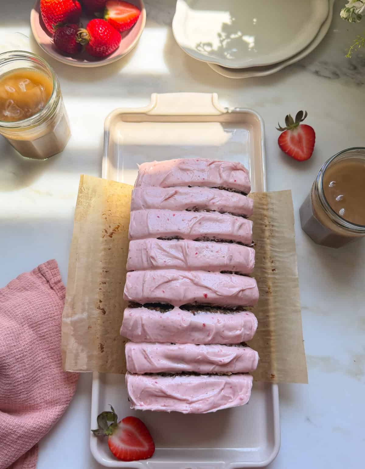 Frosted and sliced strawberry banana bread.
