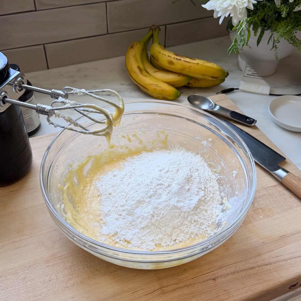 Dry ingredients added to wet ingredients in bowl.
