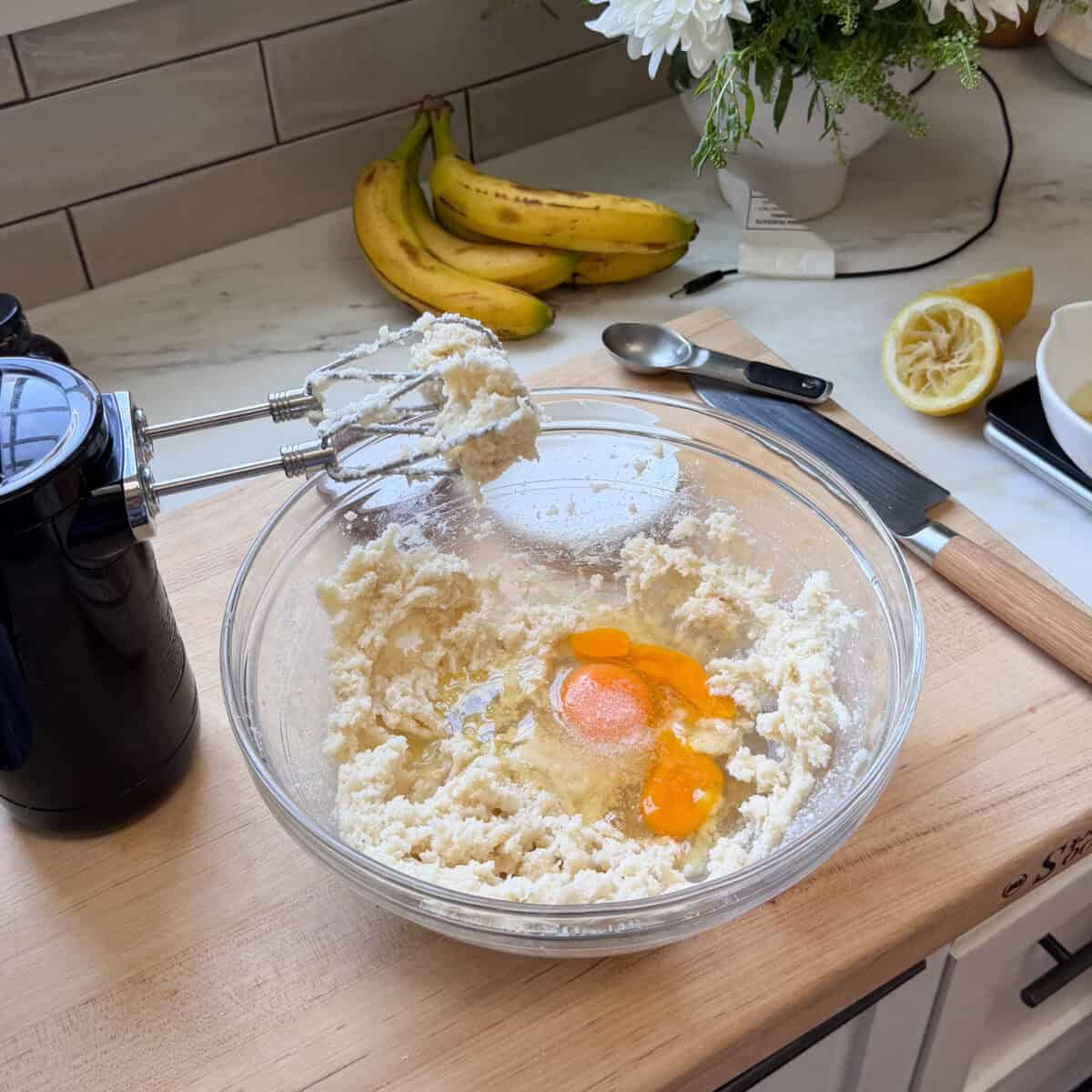 Eggs added to the butter and sugar mixture in bowl.