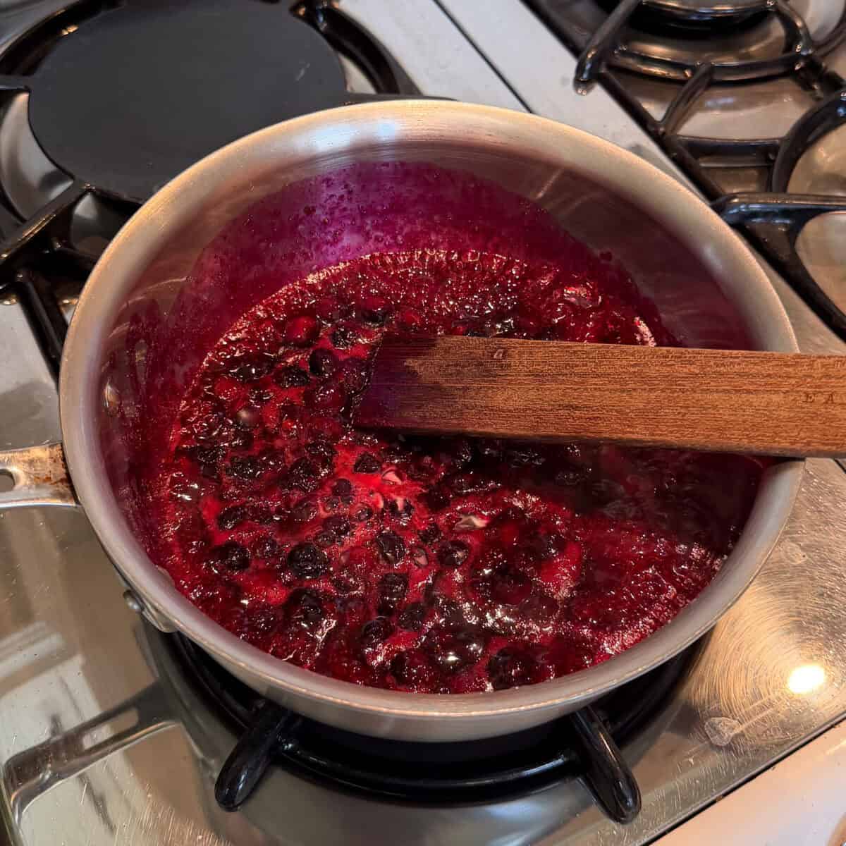 Blueberry compote simmering in pot.