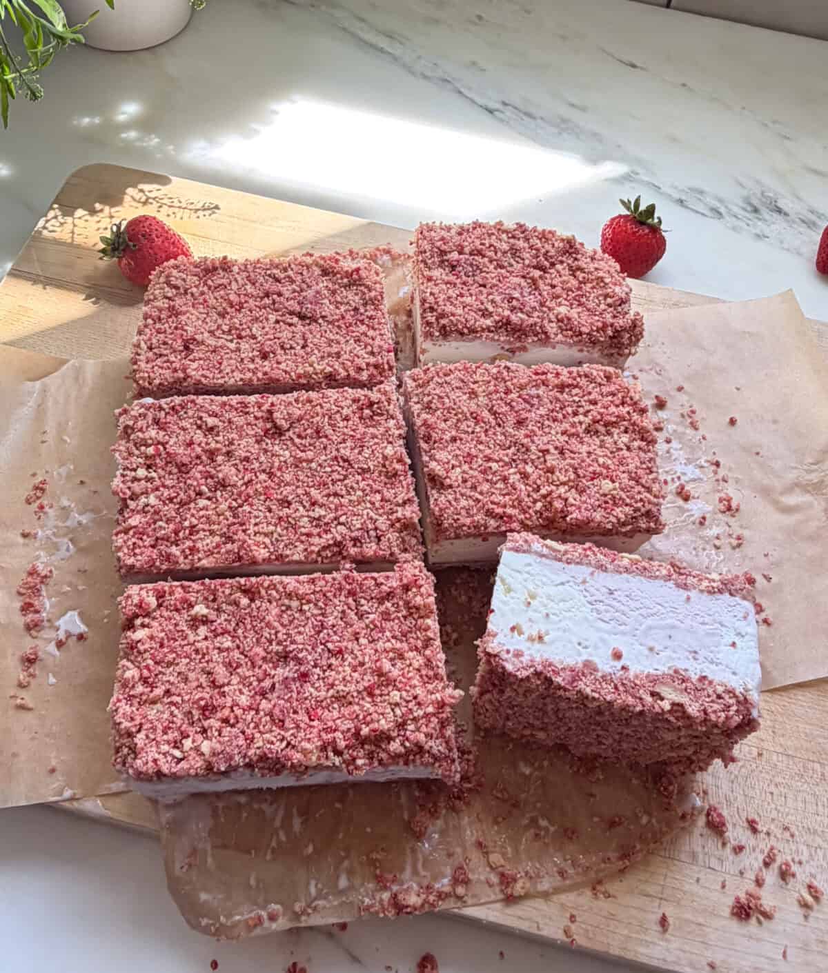 Sliced Strawberry Shortcake Ice Cream Bars on cutting board.