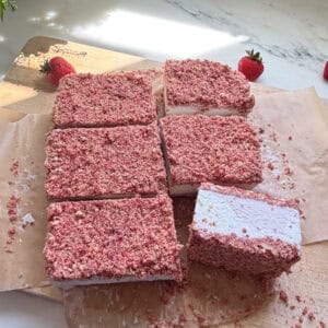 Sliced Strawberry Shortcake Ice Cream Bars on cutting board.