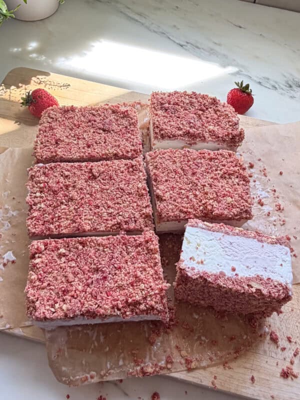 Sliced Strawberry Shortcake Ice Cream Bars on cutting board.