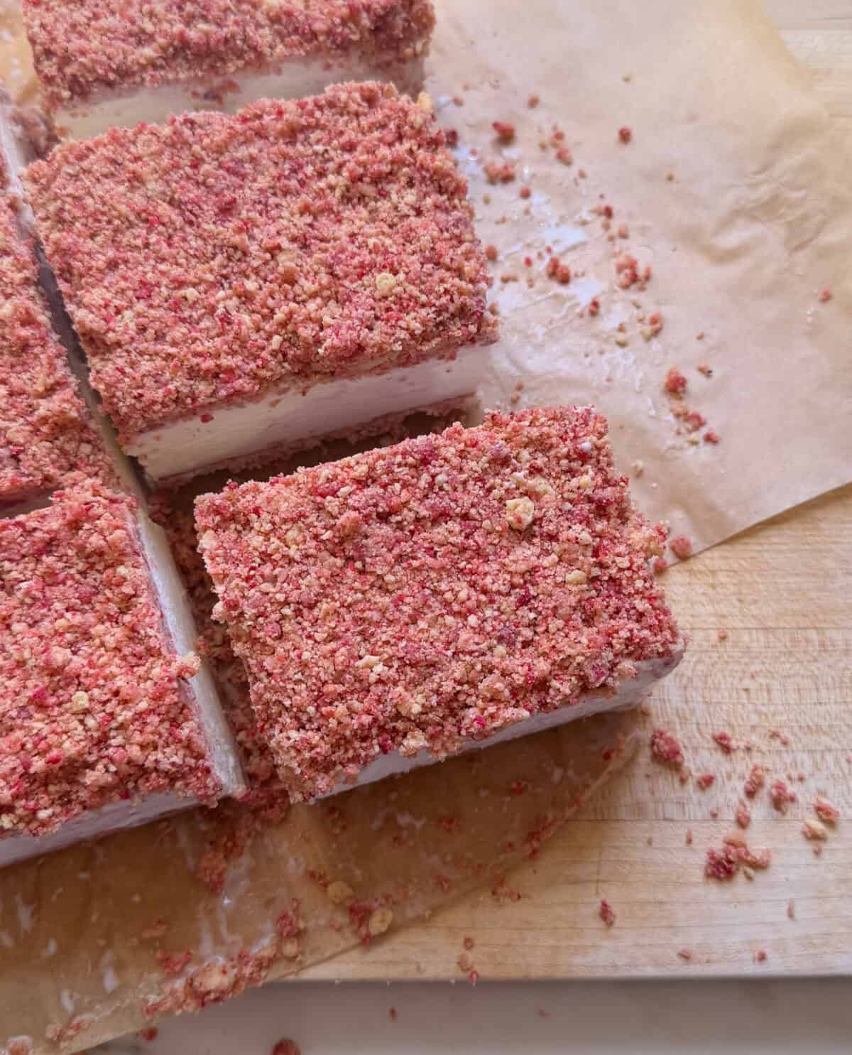 Sliced Strawberry Shortcake Ice Cream Bars on cutting board.