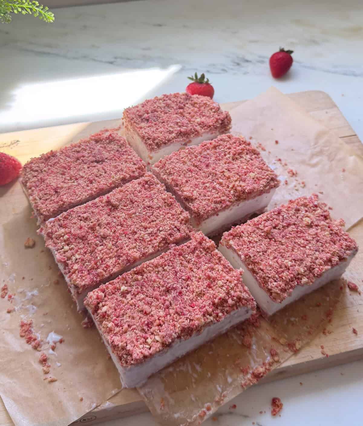 Sliced Strawberry Shortcake Ice Cream Bars on cutting board.