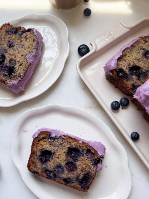 Slices of blueberry banana bread on plates.